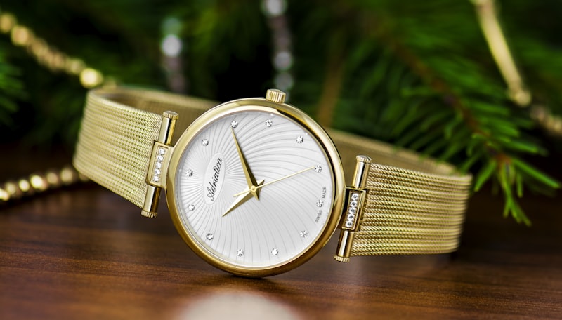 Gold mesh-strap womens watch with white textured dial