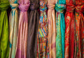 Row of colourful paisley silk scarves on display