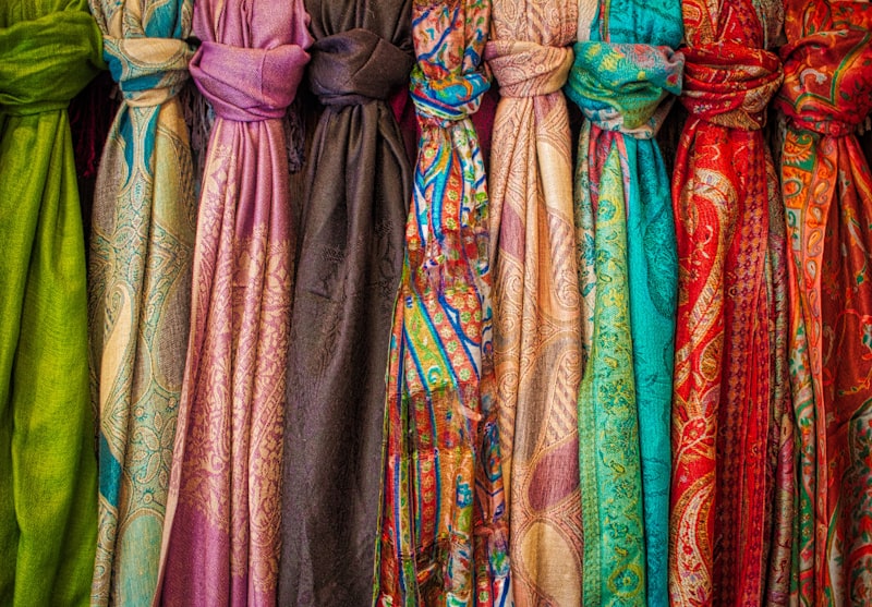 Row of colourful paisley silk scarves on display