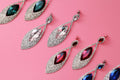 Crystal marquise drop earrings on a pink background
