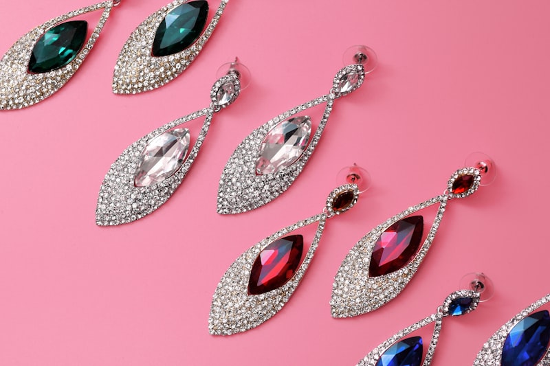 Crystal marquise drop earrings on a pink background