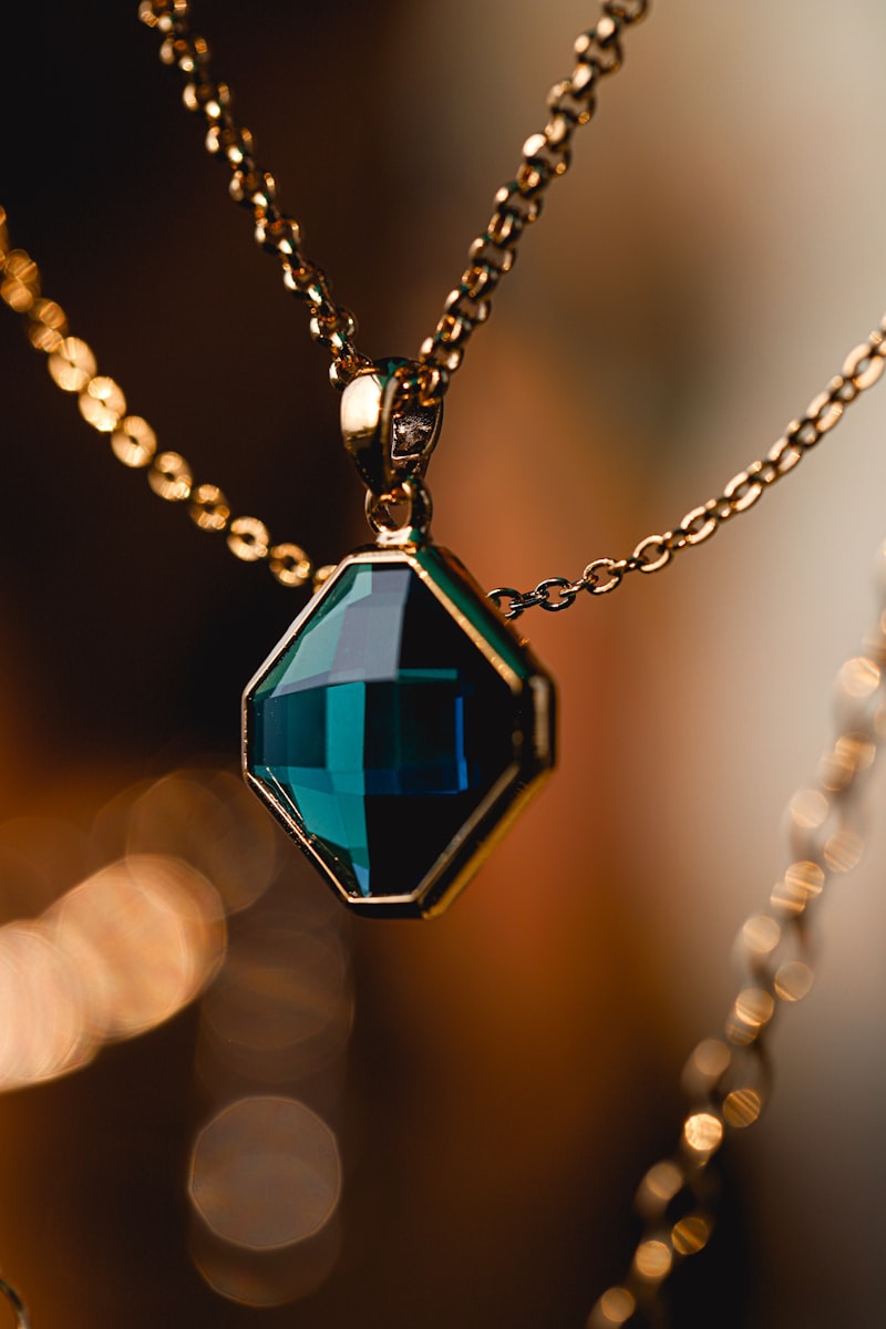 Teal octagon pendant on a gold chain necklace
