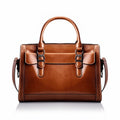 Tan cognac leather satchel handbag on a white background